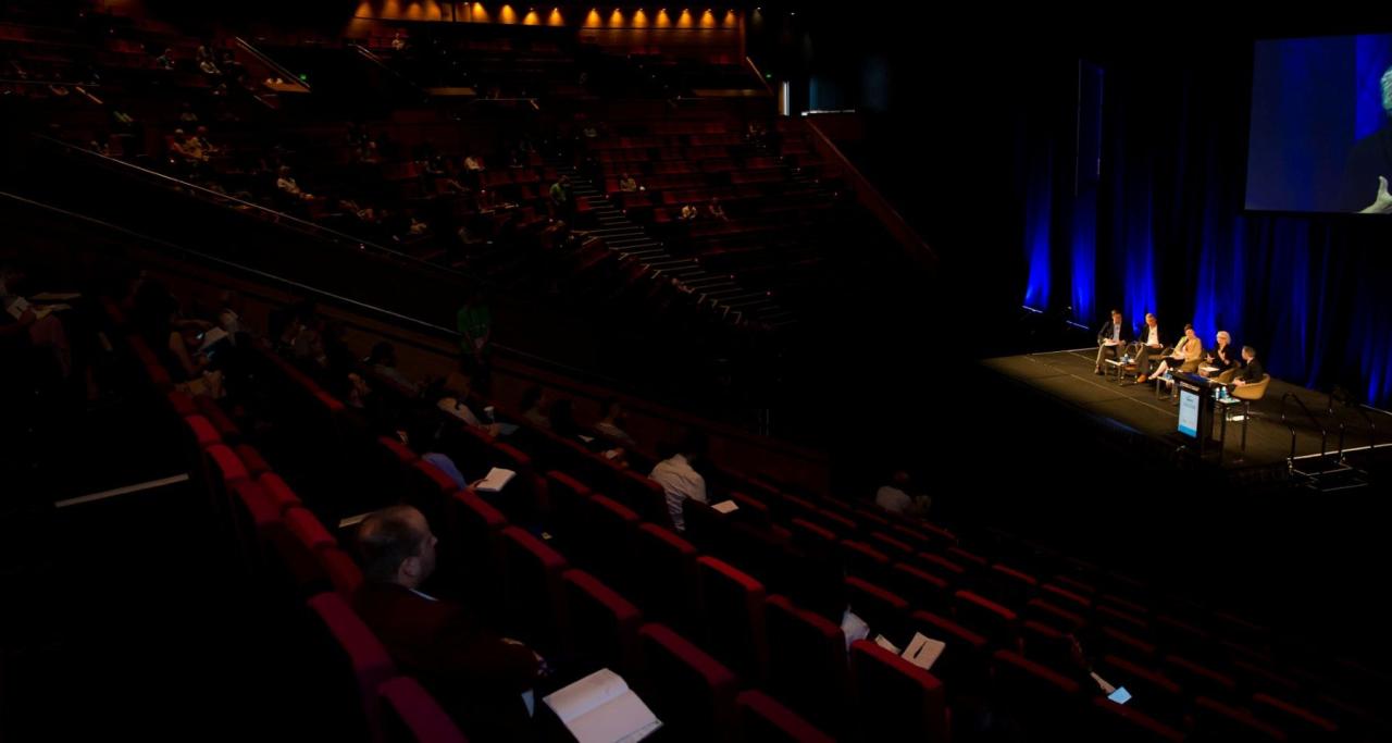 Wide view of audience and stage in conference session at National Housing Conference 2023