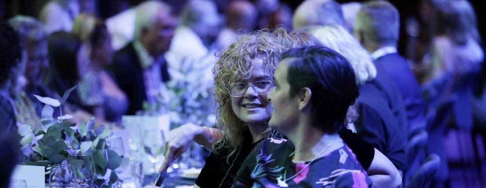 People smiling at National Housing Conference dinner