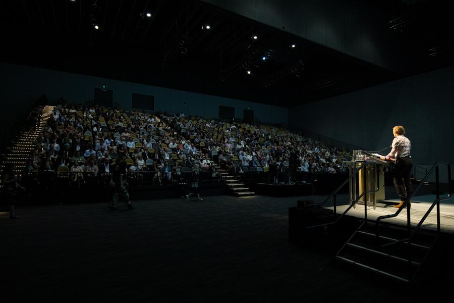 Wide view of crowd watching speaker at National Housing Conference 2022
